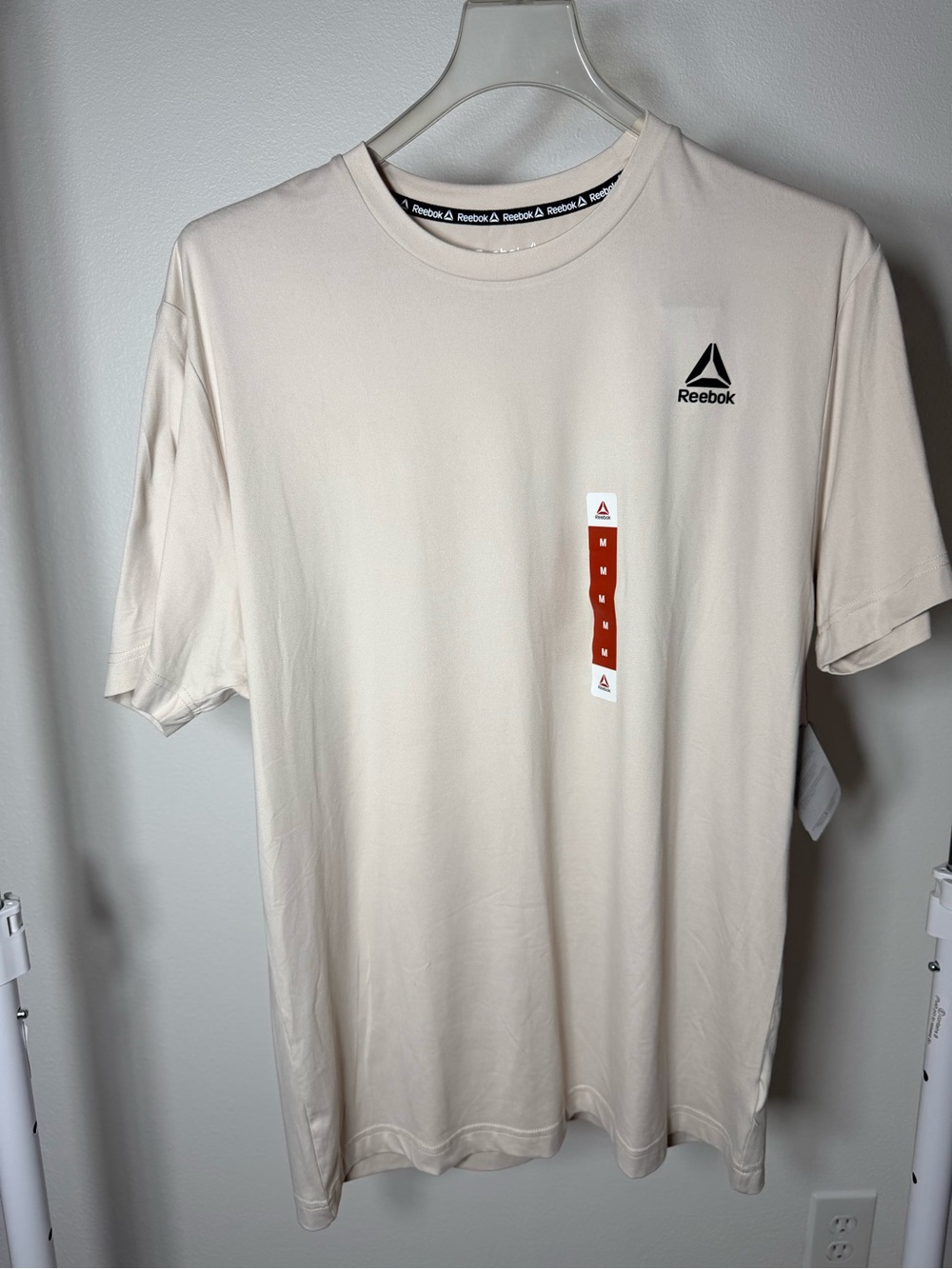 Reebok Men’s Cream Short Sleeve Athletic Tee with Black Logo